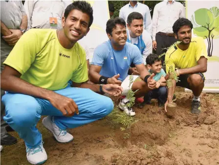  ?? — PTI ?? India team members Rohan Bopanna ( from left), Leander Paes, coach Zeeshan Ali and Saketh Myneni plant saplings at the Chandigarh Tennis Club on Thursday ahead of their Davis Cup Asia/ Oceania Group- I tie against South Korea.