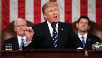  ?? The Associated Press ?? U.S. President Donald Trump addresses a joint session of Congress Tuesday on Capitol Hill in Washington. Vice-President Mike Pence and House Speaker Paul Ryan listen.