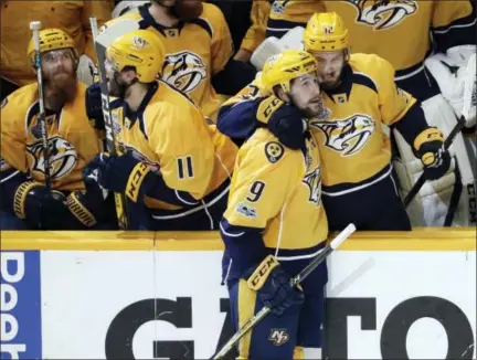  ?? MARK HUMPHREY — THE ASSOCIATED PRESS ?? Nashville Predators left wing Filip Forsberg (9), of Sweden, is congratula­ted by Frederick Gaudreau (32) after Forsberg scored an empty net goal against the Pittsburgh Penguins during the third period in Game 4 Monday in Nashville, Tenn.