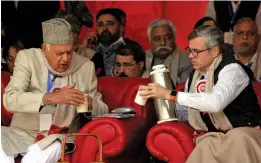  ??  ?? National Conference president Farooq Abdullah with his son and party working president Omar Abdullah after he was re-elected to the party President’s post, during a day-long state delegates’ session, in Srinagar on Sunday. — H.U.NAQASH