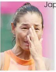  ??  ?? Japan’s Kimiko Date wipes her tears during a ceremony after her last match of her career against Serbian Aleksandra Krunic in the first round of the Japan Wemen’s Open tennis tournament in Tokyo on Tuesday. (AFP)