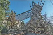  ?? THE ASSOCIATED PRESS ?? Climbing towers made of gnarled boughs lashed together with willow wands, at London’s Tumbling Bay playground.