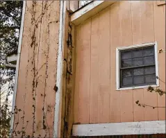  ?? NATRICE MILLER/NATRICE.MILLER@AJC.COM ?? ‘A VEHICLE FOR PROFITS’
Rotting paneling awaits repairs on the chimney at Dele Lowman’s Stonecrest home last fall. “We’re merely a vehicle for profits,” she said of her landlord VineBrook.