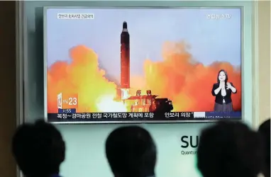  ?? PICTURE: AP ?? HOTTING UP: In this June 23, 2016, file photo, people at the Seoul Railways Station watch a TV image of North Korea’s ballistic missile launch. North Korea could soon be capable of targeting America with nuclear weapons.