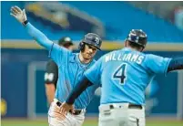  ?? CHRIS O’MEARA/AP ?? Tampa Bay Rays’ Brandon Lowe, left, celebrates with third-base coach Brady Williams after hitting a solo homer off Toronto Blue Jays pitcher Casey Lawrence during the third inning of a spring training game Thursday in St. Petersburg.