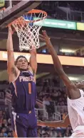  ?? JOE CAMPOREALE/USA TODAY SPORTS ?? Suns guard Devin Booker (1) dunks over Memphis Grizzlies forward Jaren Jackson Jr. Sunday.