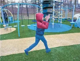  ?? JERRY JACKSON/STAFF ?? A child plays on the Orokawa Foundation Playground, built for students whose primary diagnosis is autism, at The Children’s Guild Transforma­tion Academy.