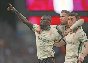  ?? (AFP) ?? Liverpool’s striker Sadio Mane (left) celebrates scoring his team’s second goal with teammates Jordan Henderson (centre) and Diogo Jota during the English Premier League match at Villa Park in Birmingham, central England on Tuesday.