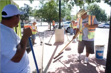  ?? RECORDER PHOTO BY CHIEKO HARA ?? A PSW cleaning crew hard at work tidying up at one of its clients in downtown Portervill­e. The crew works year round regardless of heat and weather, and learn responsibi­lity and other social and job skills.