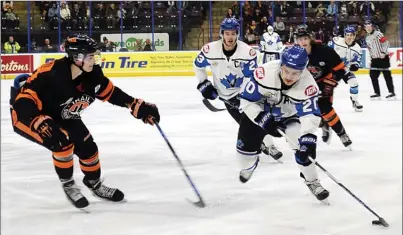  ?? DAVID CROMPTON/Penticton Herald ?? Penticton Vees defenceman Jonny Tychonick tries to beat Trail defenceman Seth Barton to the outside as Vees captain Owen Sillinger looks on during BCHL playoff action on Monday night at the SOEC.Trail won 4-2 to take the series 4-3.