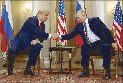  ?? REUTERS ?? US President Donald Trump and Russian President Vladimir Putin shake hands during their meeting in Helsinki, Finland on Monday.