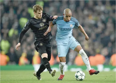  ?? — AFP ?? Celtic midfielder Stuart Armstrong (left) vies with Manchester City’s Fernando during the UEFA Champions League group C match at the Etihad Stadium in Manchester, northern England.