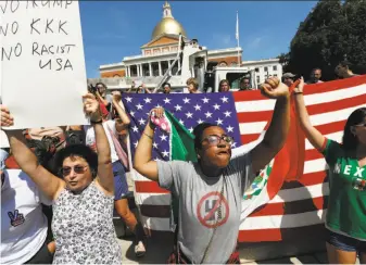  ?? Michael Dwyer / Associated Press ?? Counterpro­testers hold signs and chant at the Massachuse­tts Statehouse before a planned “Free Speech” rally by conservati­ve organizers on the adjacent Boston Common.