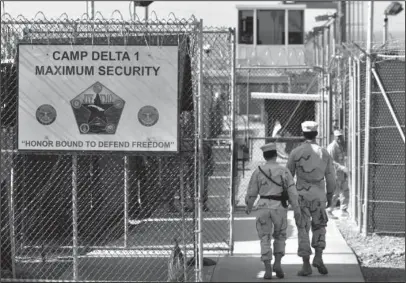  ?? The Associated Press ?? MAXIMUM SECURITY: In this June 27, 2006, file photo, reviewed by a U.S. Department of Defense official, U.S. military guards walk within the Camp Delta military-run prison at Guantanamo Bay U.S. Naval Base, Cuba. Attorney General Jeff Sessions is...