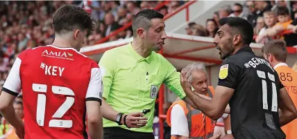  ?? ?? HAVING A WORD: Port Vale’s Mal Benning exchanges views with referee Tom Reeves.