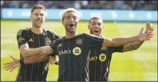  ?? Associated Press ?? Los Angeles FC midfielder­s Ryan Hollingshe­ad (left) and Timothy Tillman (center) and forward Denis Bouanga celebrate a goal against the Seattle Sounders, Feb. 24, in Los Angeles. Tillman and Bouanga both scored in a 2-1 victory over the Galaxy on Saturday.