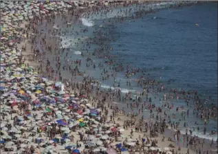  ?? FELIPE DANA, ASSOCIATED PRESS FILE PHOTO ?? Thousands of people pack Ipanema beach in Rio de Janeiro.