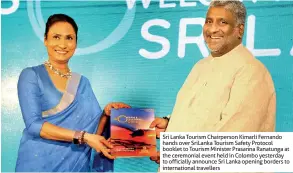  ??  ?? Sri Lanka Tourism Chairperso­n Kimarli Fernando hands over Srilanka Tourism Safety Protocol booklet to Tourism Minister Prasanna Ranatunga at the ceremonial event held in Colombo yesterday to officially announce Sri Lanka opening borders to internatio­nal travellers