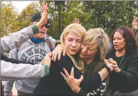  ?? (AP/Jacquelyn Martin) ?? Christians hug while praying in support of Supreme Court nominee Amy Coney Barrett outside the Supreme Court on Capitol Hill in Washington.