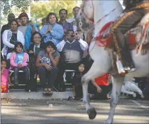  ?? NEWS-SENTINEL FILE PHOTOGRAPH ?? The audience watches as Amigos de a Caballo de Candelario Villalobos perform during the Dia del Campesino celebratio­n at Hale Park in Lodi on Oct. 26, 2014. The festival returns Sunday.