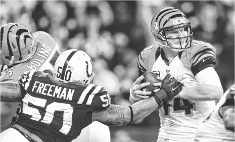  ?? ANDREW WEBER, USA TODAY SPORTS ?? Bengals quarterbac­k Andy Dalton, right, now 0-4 in the postseason, is sacked by Colts linebacker Jerrell Freeman on Sunday.