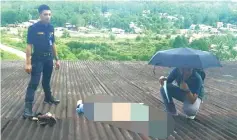  ??  ?? Police at the spot on the roof where the victim landed in the fall from the 10th floor of the female hostel yesterday.