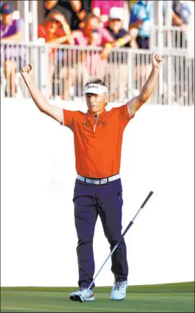  ?? ?? Bernhard Langer celebrates after making his birdie putt, left, which won him the Dominion Energy Charity Classic after a playoff with Doug Barron on Sunday in Richmond, Va. Langer holds his trophy, right.