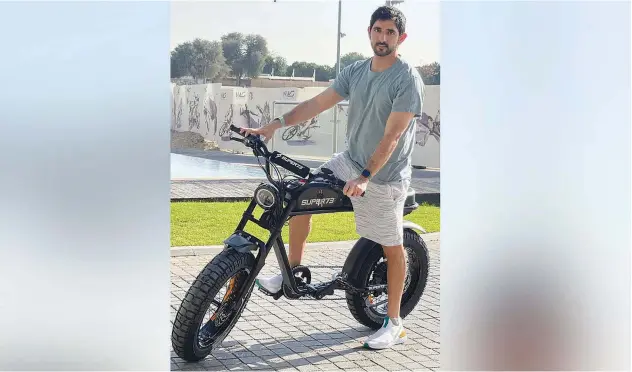  ??  ?? ↑
Sheikh Hamdan poses with the SUPER73 electric motorbike in Dubai.