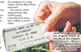  ??  ?? Janet Huey displays her original ticket at the site of the original Woodstock Music Festival in Bethel, New York, on Aug 14, 2009. — Reuters file photo