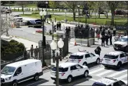  ?? J. SCOTT APPLEWHITE — THE ASSOCIATED PRESS ?? Police officers gather near a car that crashed into a barrier on Capitol Hill in Washington, Friday.