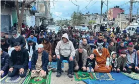  ?? Photograph: Anadolu/Getty Images ?? Muslims perform Eid al-Fitr prayer in the street next to the rubble of Rafah’s al-Farouk mosque.