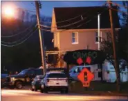  ?? JOHN MINCHILLO — THE ASSOCIATED PRESS FILE ?? In this Sunday file photo, a coroner’s unit pulls away as police operate at a crime scene outside the Cameo club after a fatal shooting, in Cincinnati.