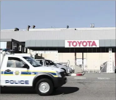  ?? PHOTO: REUTERS ?? A police vehicle drives in front of the Toyota plant in Durban. According to Naamsa, the auto manufactur­ing industry market had held up relatively well, despite the challengin­g economic environmen­t.