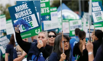  ?? September. Photograph: Mike Blake/Reuters ?? Registered nurses at Kaiser Permanente conduct a one-day picket outside one of the company’s three medical centers in San Diego, California, on 19