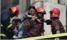  ??  ?? A survivor is rescued by firefighte­rs. Photograph: Munir Uz Zaman/AFP/Getty