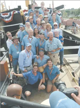  ?? SEAN D. ELLIOT/THE DAY ?? Shipyard staff gather for a photo in front of the Charles W. Morgan as the Mystic Seaport relaunches the ship on July 21, 2013.