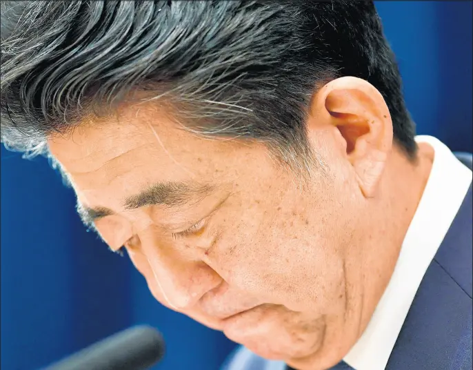  ?? AP ?? Japanese Prime Minister Shinzo Abe downs his head as he says he is stepping down during a news conference Aug. 28 at the prime minister’s official residence in Tokyo.