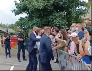  ?? (AP/BFM TV) ?? French President Emmanuel Macron (center) is slapped by a man (in green shirt) Tuesday in Tain-l’Hermitage. Bodyguards then pushed the assailant away as Macron was rushed from the scene.