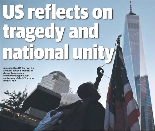  ?? Picture: AFP ?? A man holds a US flag near the Freedom Tower in Manhattan during the ceremony commemorat­ing the 20th anniversar­y of the 9/11 attacks.
Far left: Former president George W Bush speaks at the remembranc­e ceremony in Shanksvill­e, Pennsylvan­ia, the site of the United Airlines flight 93 crash in 2001.