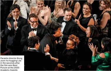  ?? Parasite director Bong Joon-ho hugging Lee in the seconds after the film won Best Picture at the 2020 Academy Awards ??