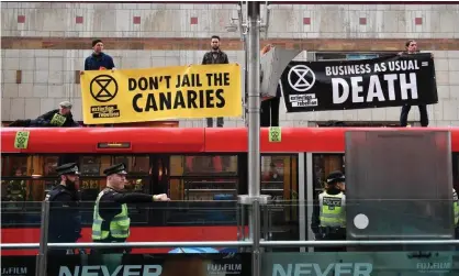  ?? ?? Activists on the roof of a DLR train at Canary Wharf station on 25 April 2019. Photograph: Daniel Leal-Olivas/AFP/Getty