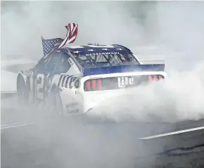  ?? GETTY IMAGES ?? Brad Keselowski celebrates with a burnout after winning the NASCAR Cup Series Coca-Cola 600 at Charlotte Motor Speedway.