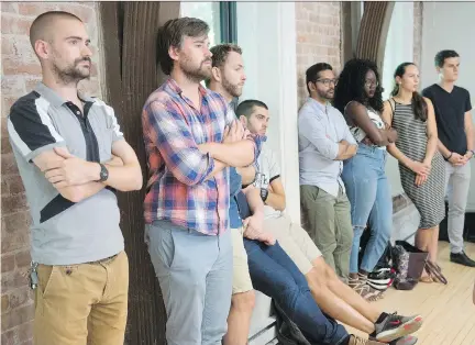  ?? RYAN REMIORZ/THE CANADIAN PRESS ?? Uber staff listen to Jean-Nicolas Guillemett­e, Uber Quebec’s general manager, during a news conference in Montreal on Tuesday. Guillemett­e says the company won’t follow the government’s rule on training drivers, insisting it already delivers...