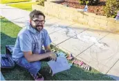  ?? EDUARDO CONTRERAS U-T ?? Erick Toussaint works on one of his sidewalk chalk art creations Friday outside his Ocean Beach home.