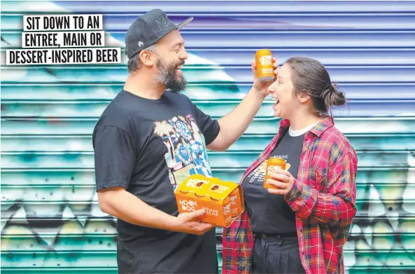  ?? ?? Melbourne's Moon Dog Brewery brand manager Miro Bellini shares a can with co-worker Bianca Humphries.