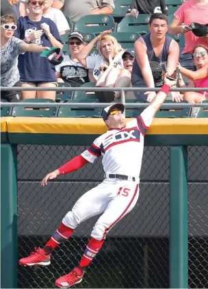  ??  ?? Adam Engel reaches high over the fence to take a home run away from Yonder Alonso in the eighth inning. Engel also had homer-saving snags Monday and Tuesday against the Yankees.