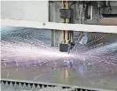  ?? [PHOTOS PROVIDED BY MODINEER] ?? A laser cutter works on a sheet of aluminum at one of Modineer’s facilities. Company officials say they continuall­y invest in new machines to improve capabiliti­es.