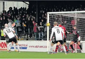  ??  ?? Two good Gary Harkins doubles Ayr’s lead with a header