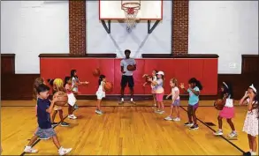  ?? Ned Gerard / Hearst Connecticu­t Media ?? UConn forward Richie Springs works with summer campers during a visit to the Wakeman Boys & Girls Club Monday in Fairfield.