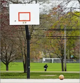  ?? SEAN D. ELLIOT/THE DAY ?? An abandoned basketball rests on a vacant court beneath a de-hooped backboard Monday at Sutton Park in Groton.